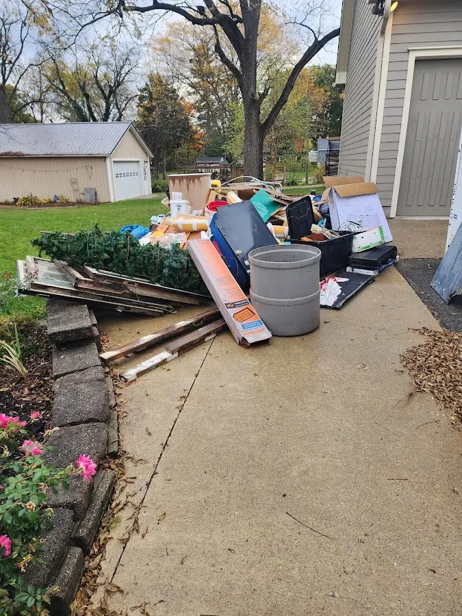 Dumpster being loaded with debris for 3 Yard Dumpster Rental in Bellefontaine